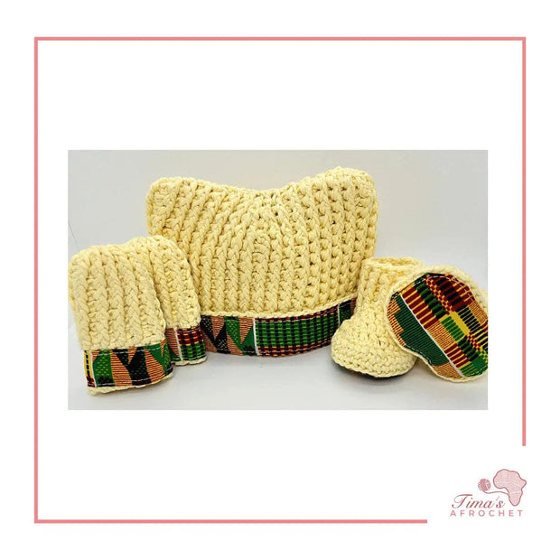  Image is a light yellow crochet bundle set which includes hat, booties, mittens. Each item has African fabric on the soles and rims.  Perfect for keeping baby stylish, comfortable and representing culture.