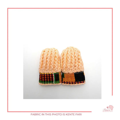 Image is a pair of crochet PEACH baby mittens with authentic African Ankara fabric on the rim where the wrists is.Perfect for keeping baby stylish, comfortable and representing culture. 