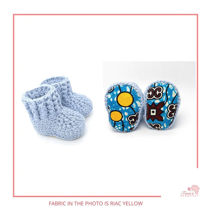 Image is a pair of crochet light blue baby shoes with a white bow and authentic African Ankara  fabric on the soles. Perfect for keeping baby stylish, comfortable and representing culture.