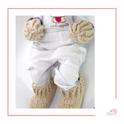 Image is a light beige crochet bundle set which includes hat, booties, mittens. Each item has African fabric on the soles and rims.  Perfect for keeping baby stylish, comfortable and representing culture.