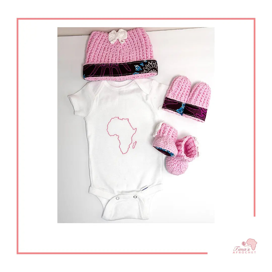  Image is a pink crochet bundle set which includes hat, booties, mittens. Each item has African fabric on the soles and rims.  Perfect for keeping baby stylish, comfortable and representing culture. There is also an embroidered shirt shaped of africa for baby onsie.
