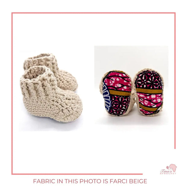 Image is a pair of crochet light beige baby shoes with a white bow and authentic African Ankara  fabric on the soles. Perfect for keeping baby stylish, comfortable and representing culture.