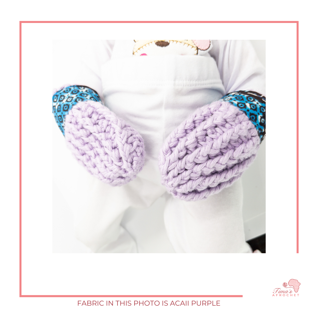 Image is a pair of crochet light purple baby mittens with authentic African Ankara fabric on the rim where the wrists is.Perfect for keeping baby stylish, comfortable and representing culture. 