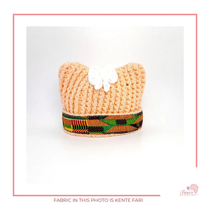 Image is a crochet PEACH baby hat with authentic African Ankara fabric on the rim. Perfect for keeping baby stylish, comfortable and representing culture. 