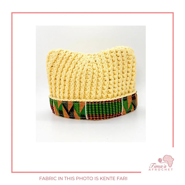Image is a crochet light yellow  baby hat with authentic African Ankara fabric on the rim. Perfect for keeping baby stylish, comfortable and representing culture. 