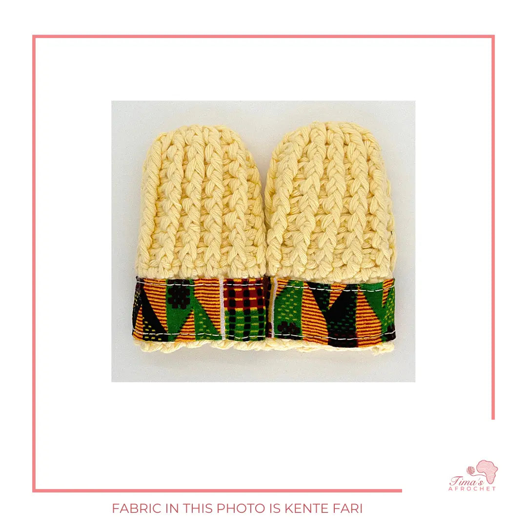 Image is a pair of crochet light yellow baby mittens with authentic African Ankara fabric on the rim where the wrists is.Perfect for keeping baby stylish, comfortable and representing culture. 