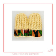 Image is a pair of crochet light yellow baby mittens with authentic African Ankara fabric on the rim where the wrists is.Perfect for keeping baby stylish, comfortable and representing culture. 