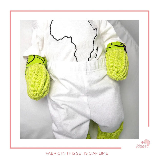Image is a baby doll wearing crochet mittens and booties with african fabric on the sole.