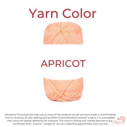 Image is a ball of peach color yarn